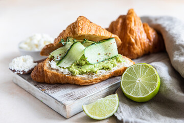 Croissant sandwich with cream cheese, nectarine and cherry and fresh ingredient for making tasty breakfast.