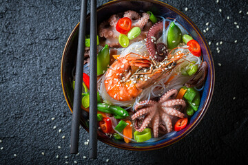 Tasty seafood noodle with octopus and shrimps. Classic seafood noodle. © shaiith