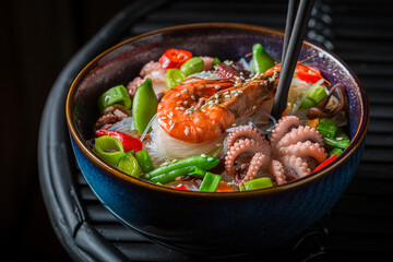 Spicy seafood noodle with prawn and octopus. Classic seafood noodle.