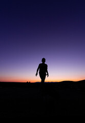 SILHOUETTE OF A CHILD APPROACHING DURING SUNSET