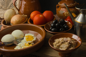 Still life with tomato, olives, eggs, tuna, olive oil to cook Moje, mojete, Spanish food from Murcia and Albacete