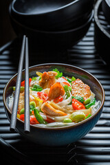 Hot noodle with vegetables and chicken. Asian cuisine.