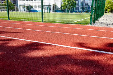 Red treadmill on sport field. Running track on the stadium