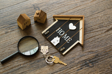 Wooden house model with stethoscope on wood background. Concept of House Inspection.