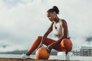 Fitness woman resting after workout on rooftop