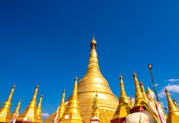 Naklejka premium A group of golden pagodas under the blue sky of Myanmar