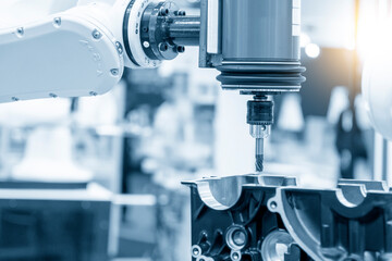 The automotive parts finishing process by milling process attached the robotics arm.