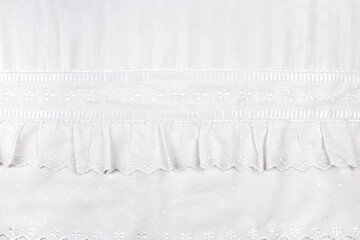 background of white embroidered fabrics, decorative lace.