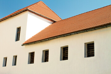 red tile roof on an old house with latticed windows