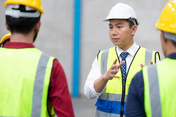 factory workers or foreman talking about project with colleague before start a work