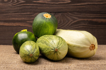 zucchini of different varieties on a wooden background