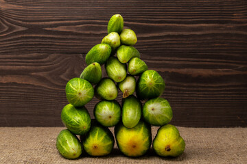 a pile of fresh cucumbers  on a wooden background