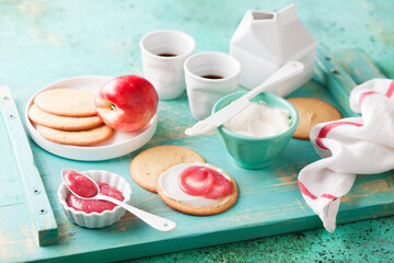 Homemade gluten free vegan paleo diet cookies with peach jam and butter or shortening for breakfast, selective focus