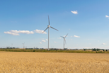 Wind power plants on the background of half and blue sky
