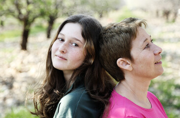 Fototapeta premium portrait of mom and teenage daughter outdoors