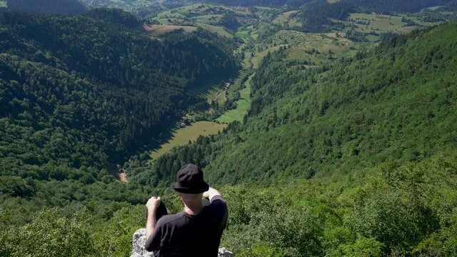 Man observes mountain landscape in summer, Vlasic, Bosnia and Herzegovina - (4K)