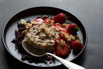 NUTRTIOUS BREAKFAST PLATE PORRIDGE OATS NUTS NUTS SEEDS METAL SPOON DARK PLATE 