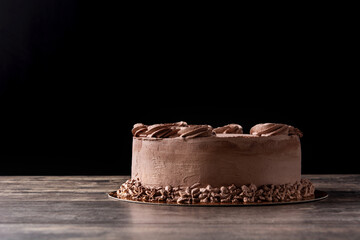 Piece of chocolate truffle cake on wooden table	