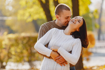 Beautiful couple spend time on a autumn park