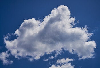 white clouds float across the blue sky