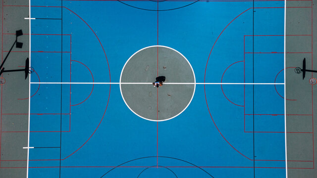 Chico joven tatuado fitnes en cancha  de baloncesto