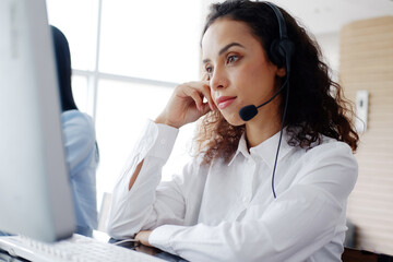 Smling Caucasian woman call center or secretary operator with headset and microphone is thinking...