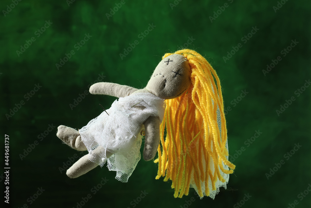 Canvas Prints female voodoo doll with pins and smoke on green background