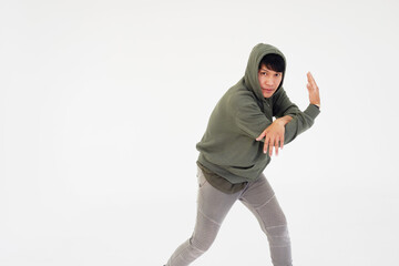 Smiling Asian young professional dancer man is break dancing by isolataed on white background in studio. Education and sport for hobbies concept.