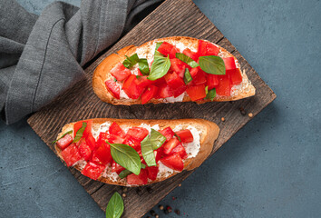 Fried toast with tomatoes, feta, and basil close-up.