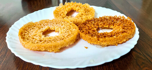 Popular and traditional Indian Rajasthani sweet dessert called Ghevar or Ghewar