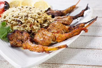 A view of a plate of Persian style lamb chops.