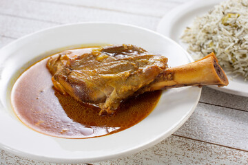 A view of a plate of braised lamb shank.