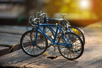 Naklejka na ściany i meble selected focus on vintage classic bike or bicycle model or toys standing on wooden table with blur bokeh background.