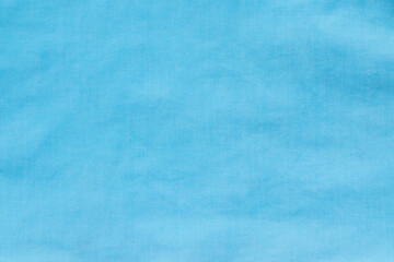 The texture of uneven natural cotton blue fabric, abstract background.