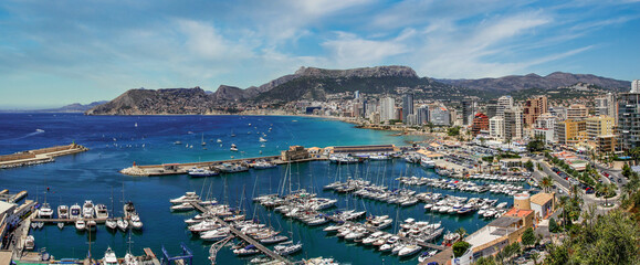 Fototapeta na wymiar panoramic view of a marina and beaches and mountains in the background in the city of Calpe. Coastal city located in the Valencia Community, Alicante, Spain