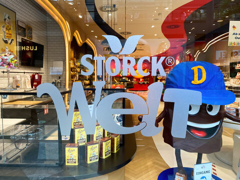Oberhausen, Germany - July 9. 2021: View on display window of store with logo lettering of storck welt sweets company in shopping mall