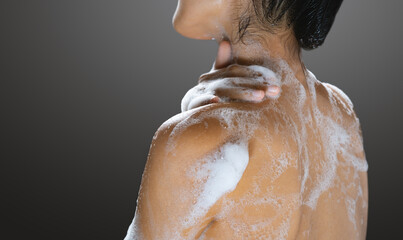 woman taking a shower with soap.skin health