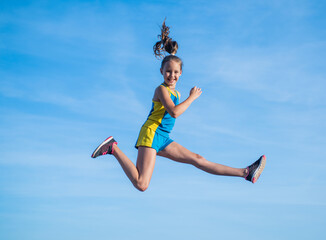 sense of freedom. energetic teen girl jumping on sky background.
