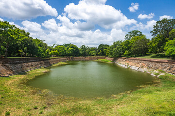 Fototapeta premium Anuradhapura, Sri Lanka. The Elephant Pond, Eth Pokuna in the ancient city. It's the largest man-made pond at the UNESCO site of Anuradhapura