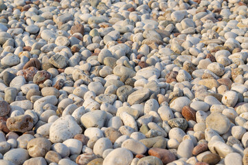 Sea stones background. Flat lay of sea stones texture background. Abstract shape pattern from nature.