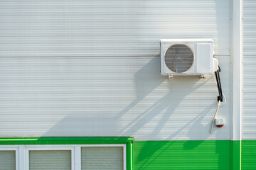 Outdoor air conditioner unit on the wall of a factory or factory. The outer wall of the enterprise...