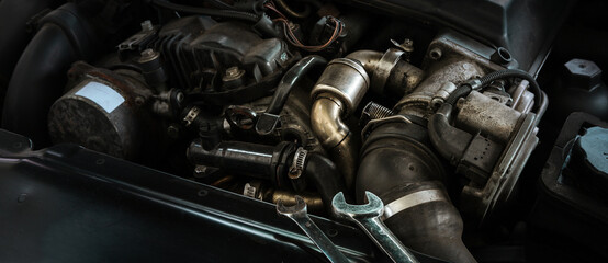 Fototapeta na wymiar Auto mechanic working on car engine in mechanics garage. Repair service. Close-up shot