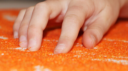 sand therapy child's hand on bright sand