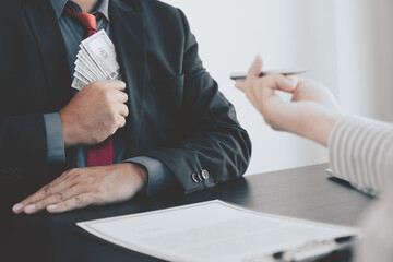 Government official hand receiving bribe money from businessman, the concept of corruption and anti-bribery