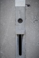 Contemporary letter box and door bell with the house number 7 on stone facia in the town of Maastricht, Netherlands