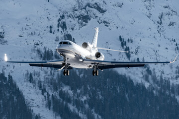 Luxury private jet approaching the engadin valley in the Swiss alps