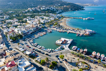 ELOUNDA, CRETE/GREECE - JULY 16 2021: Aerial view of the port and resort town of Elounda on the Greek island of Crete