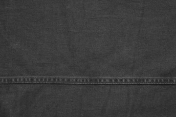 black denim with one horizontal stitch for background or wallpaper
