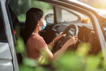 Naklejka premium woman wearing mask learning to drive at driving school