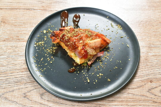 homemade pizza topping pork bacon sausage and cheese dressing mashed dry oregano with kitchup on plate